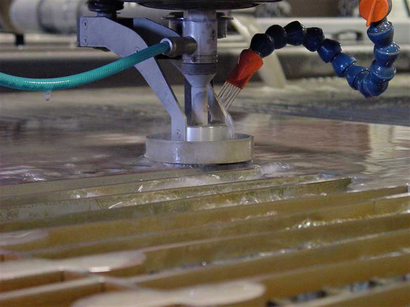 Waterjet cutting machine cutting sheet metal at Miro Manufacturing.